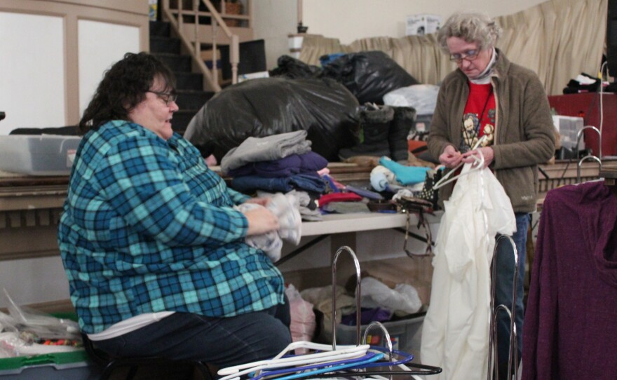 Roxanne Lent folds clothes for The Storehouse, a clothing ministry of Biker Church USA in Bangor, Maine.