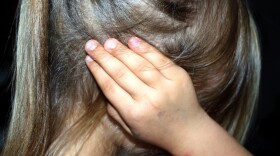 Child covering her ears