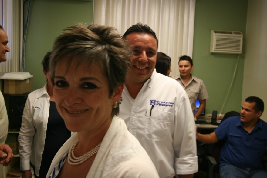Lolita Montaño smiles as she walks out of an office inside City Hall in Agua Prieta.