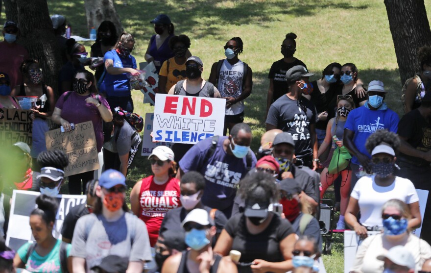 Protesters listen to a speaker during a demonstration against police brutality organized by the Next Generation Action Network in Dallas on Saturday.