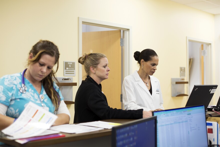 Dr. Lannis Hall, right, looks at scans before meeting with patients at a Siteman Cancer Center satellite site in St. Peters. May 31, 2018