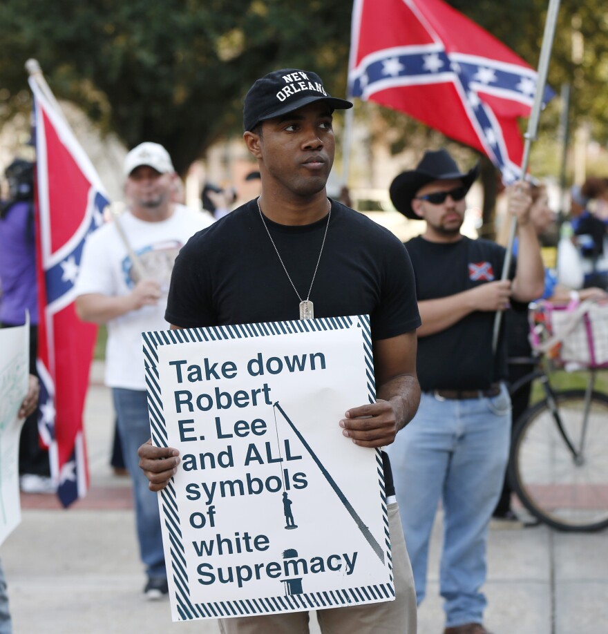 People demonstrate for and against the Confederate monuments in front of City Hall this month.