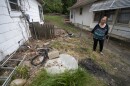 Patricia Losiewicz, a longtime resident of the Swope Ridge neighborhood, looks at a hole in the ground that is her septic system. "It's a hole in the ground full of poop," she said. "There's no other way to put it." The neighborhood was promised a sewer system years ago, but the funds for the project were diverted to help build the Swope Soccer Village located in nearby Swope Park.