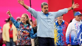 FILE - President Nicolas Maduro acknowledges supporters alongside first lady Cilia Flores during his closing election campaign rally in Caracas, Venezuela, July 25, 2024. (AP Photo/Fernando Vergara, File)