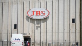 The exterior of a large blank build with a sign that says "JBS"