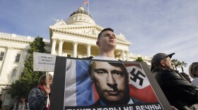 FILE— Ivan Semukhian joined others to protest the Russian invasion of Ukraine during a rally at the Capitol in Sacramento, Calif., Thursday, Feb. 24, 2022. Roughly 18,000 Ukrainians live in the Sacramento region and the area is preparing for the possibility of many more Ukrainians arriving after U.S. President Joe Biden announced the nation will accept up to 100,000 refugees from the country. (AP Photo/Rich Pedroncelli, File)