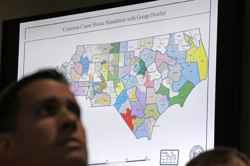 File photo of a districts map shown as a three-judge panel of the Wake County Superior Court presides over the trial of Common Cause, et al. v. Lewis, et al at the Campbell University School of Law in Raleigh, N.C., Monday, July 15, 2019.
