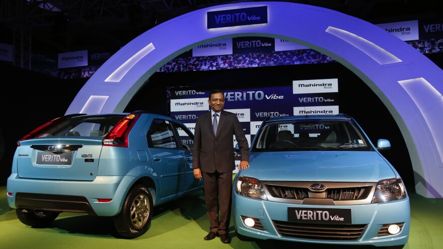 Pawan Goenka of the Indian manufacturing company Mahindra poses with the Verito Vibe compact car in Mumbai in 2013.
