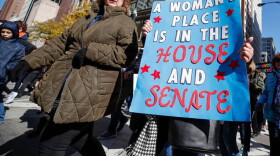 A woman holds a sign during a rally and march on October 13, 2018 in Chicago. (Kamil Krzaczynski/AFP/Getty Images)