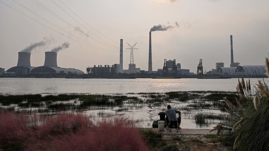 Scientists warn the world needs to dramatically reduce fossil fuel use, but many countries still depend on coal power, like from the Wujing Coal-Electricity Power Station in Shanghai, China. [HECTOR RETAMAL / AFP via Getty Images]