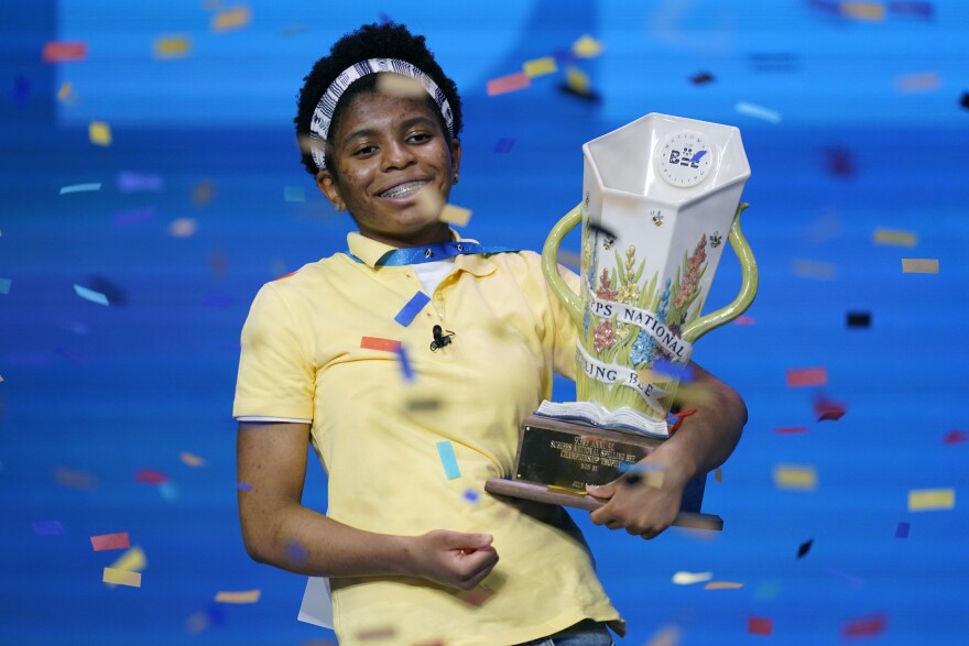 Zaila Avant-garde, 14, from Harvey, Louisiana, celebrates with the championship trophy after winning the finals of the 2021 Scripps National Spelling Bee.
