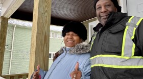 Shirley and Tyrone Dunn standing on the porch of their new home