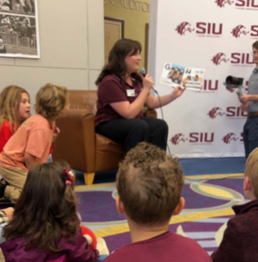 Children listen to the new "SIU A to Z" book published by the SIU Alumni Association