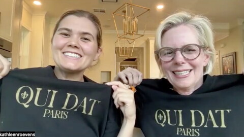 Abby and Kathleen Roevens (left to right) pose with a shirt that says 'Oui Dat" on October 2, 2026. The Roevens are New Orleans Saints fans who traveled to support the team in the NFL's first regular-season game in Paris, France.