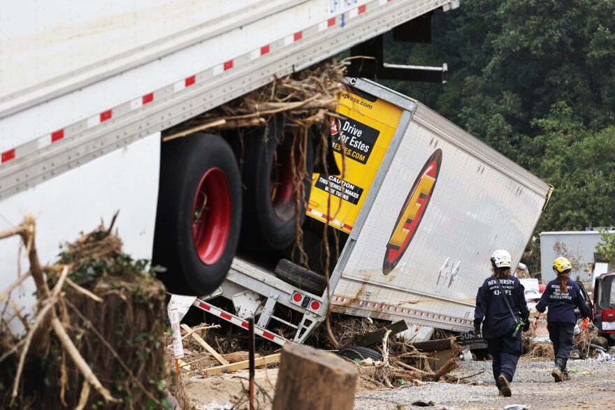 A close-up of an 18-wheeler that came lose with debris around it