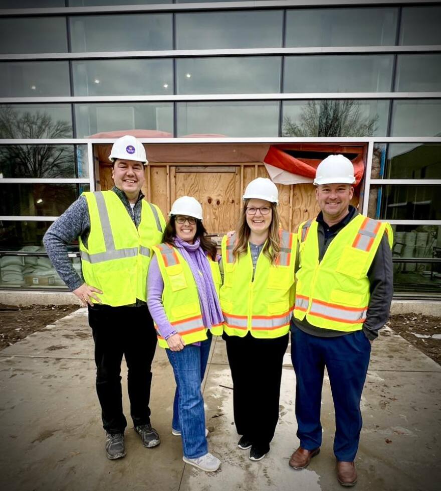Patrick Downing (left) is a 2009 WIU alum who is director of development for Western's College of Fine Arts and Communications, pictured in January 2026 with other development officers outside the new Goldfarb center.