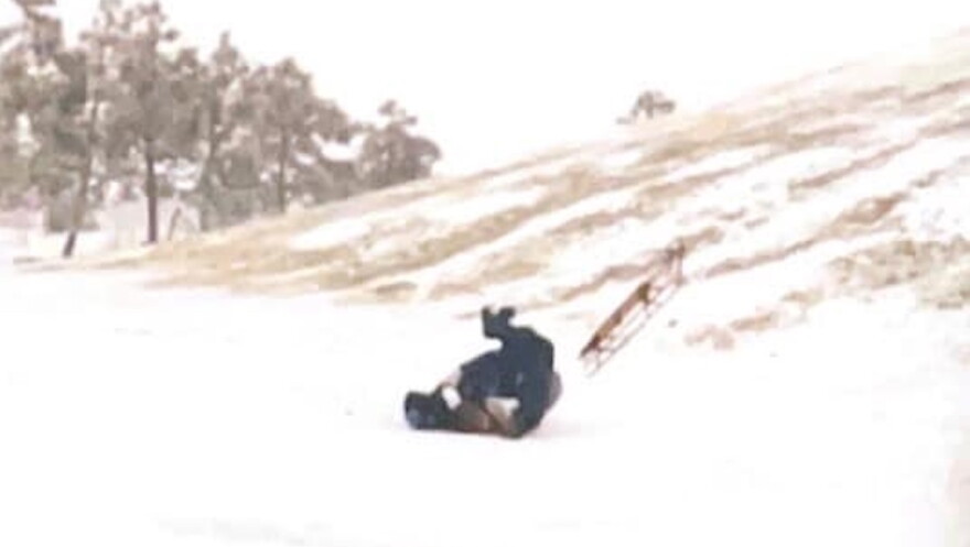 Photo by John Hill. Jamie Hill sliding down Mt. Trashmore in 1996. The sled is flying away to the right.