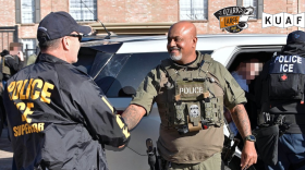 Houston-based immigration officials greet each other after December arrests involving the smuggling of immigrants on a tractor trailer. A revived “task force” cooperation program will let state and local law enforcement coordinate with the Trump administration on immigration arrests during routine police work.