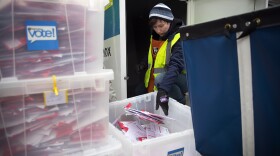 King County Elections employee Josephine Ruff unloads a  full ballot drop box outside of the Seattle Public Library on Tuesday, November 7, 2017, in Ballard. 