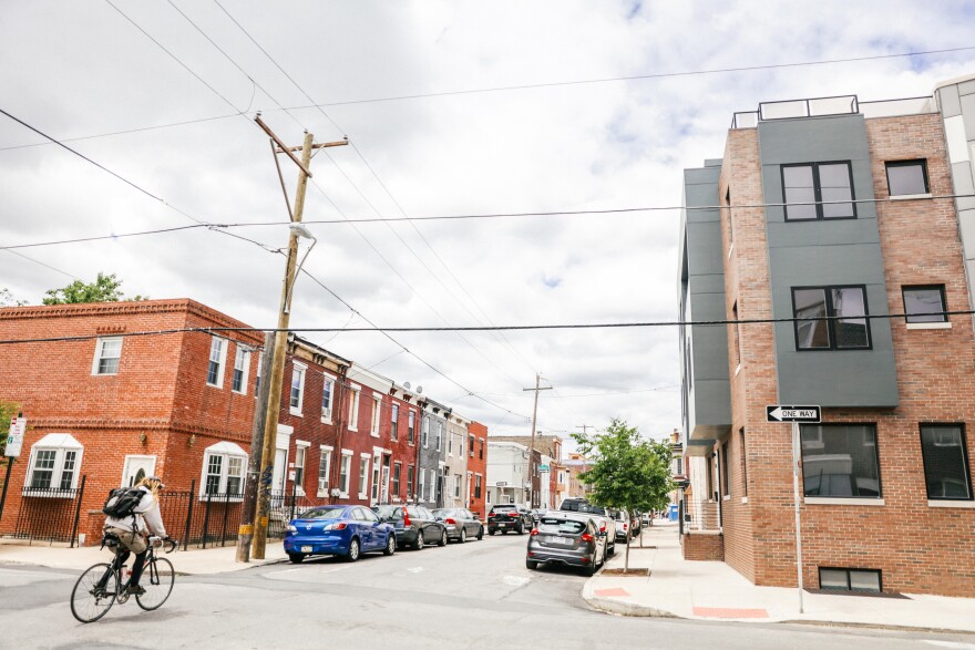 A bicyclist rides down a street in Point Breeze, one of the city’s fastest gentrifying neighborhoods.