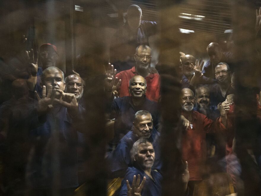 Egyptian Muslim Brotherhood defendants stand behind bars in Cairo last year during their trial, along with Mohammed Morsi, the former president who was ousted in 2013. Egypt's jails historically have bred militancy.