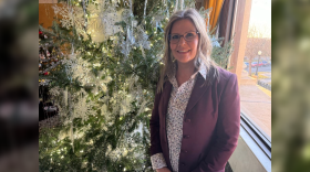 Special Projects Coordinator Leah Haugan stands with one of the 90 trees that decorate South Dakota’s state Capitol building for Christmas at the Capitol.