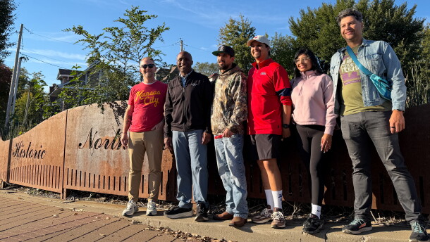Mayor Quinton Lucas poses with Kansas City residents in front of a sign that reads, "Historic Northeast."