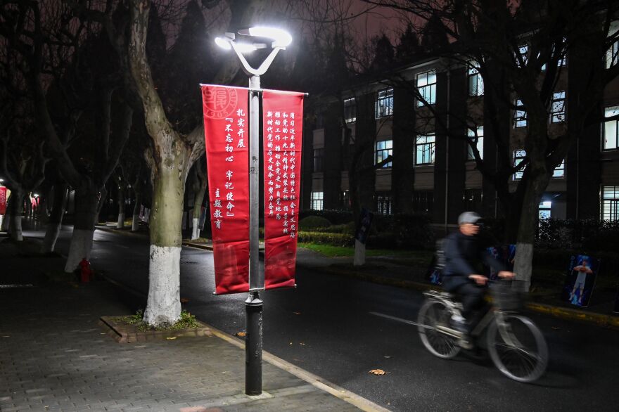 A banner calls for institutions to adhere to the political philosophy of Chinese President Xi Jinping on the campus of Fudan University in Shanghai. When the university removed references to "freedom of thought" from its charter, it triggered a rare act of student defiance.