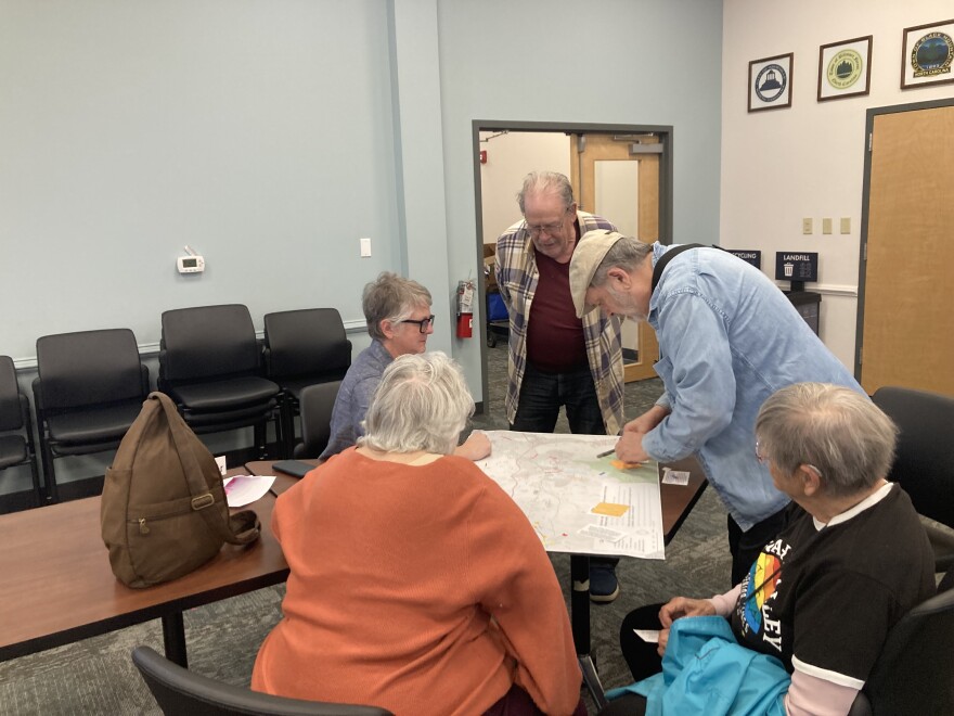 Buncombe County residents speak with staff and volunteers during a community meeting Monday, March 9, 2026.
