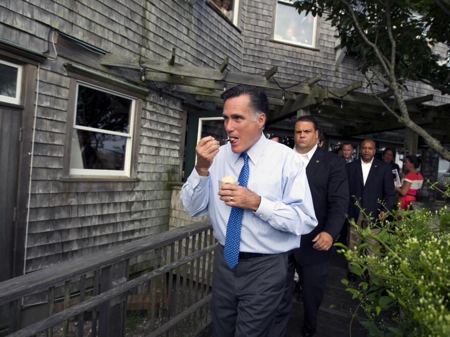 Republican presidential candidate Mitt Romney eats ice cream from Millie's on the run before a fundraising event earlier this month in Nantucket, Mass.