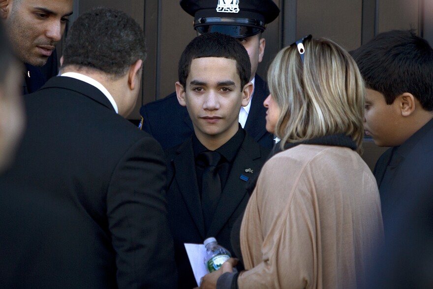 Jaden Ramos, son of slain NYPD officer Rafael Ramos, arrives for his father's wake at Christ Tabernacle Church in Queens, N.Y., on Friday.