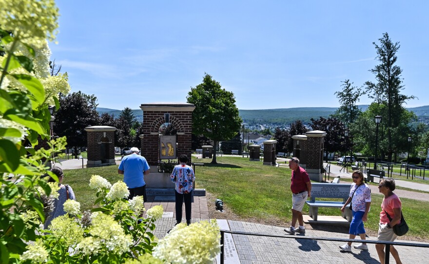 Prior to the Mass on Monday parishioners stopped at the Stations of the Cross park next to the Basilica to pray.
