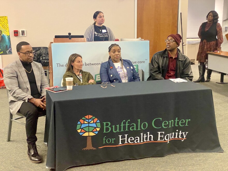 Professor Christopher St. Vil (far right) speaks at a gun violence prevention forum at Erie County Medical Center