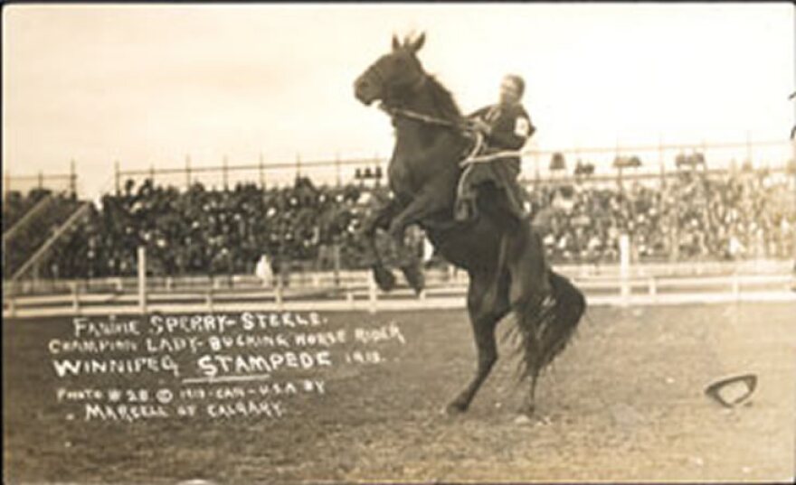 Fannie Sperry-Steele atop a rearing horse as the Champion Lady Bucking Horse Rider, Winnipeg Stampede, 1913. 