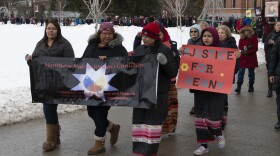 Community members carry signs and photographs of missing and murdered women and girls around UM's oval at the Native-led MMIW Vigil, Saturday, Janury 19, 2019.