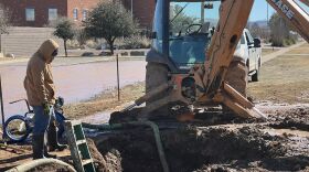 A worker examines a water line break in Alpine on Christmas Day, 2022.