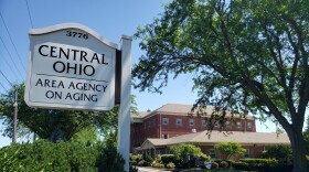 A sign on a rural street reads "Central Ohio Area Agency on Aging"