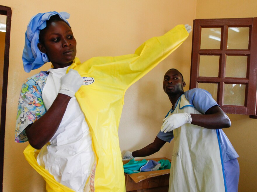 Nurse Monika Mulbah suits up before entering the Ebola ward at Firestone's clinic. Currently there are three patients, ages 4, 9 and 17.