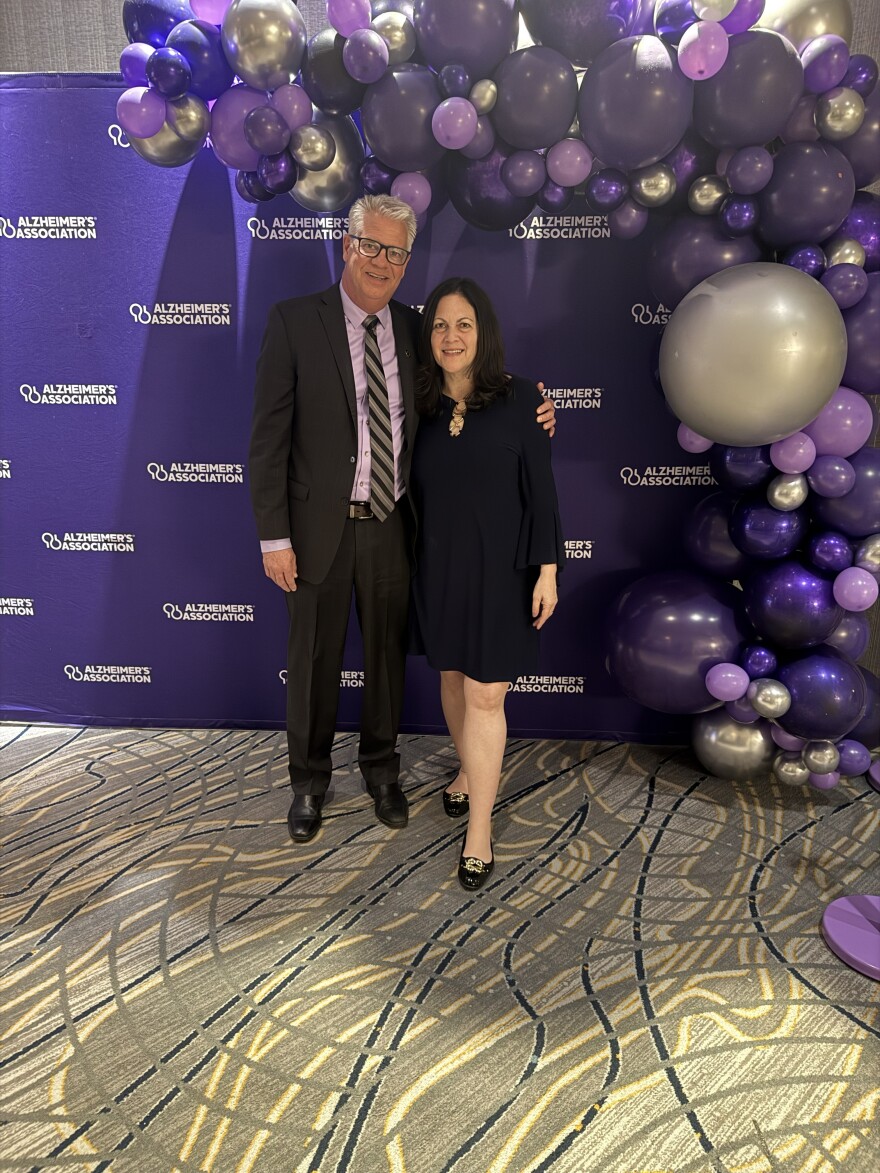 two people dressed formally at an Alzheimer's Association fundraising dinner