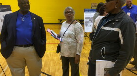 A TVA employee (left) answers questions at a public forum at the Mitchell Community Center, October 8, 2019. 