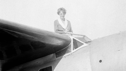 FILE - In this undated file photo, Amelia Earhart, the first woman to cross the Atlantic Ocean by plane sits on top of a plane.