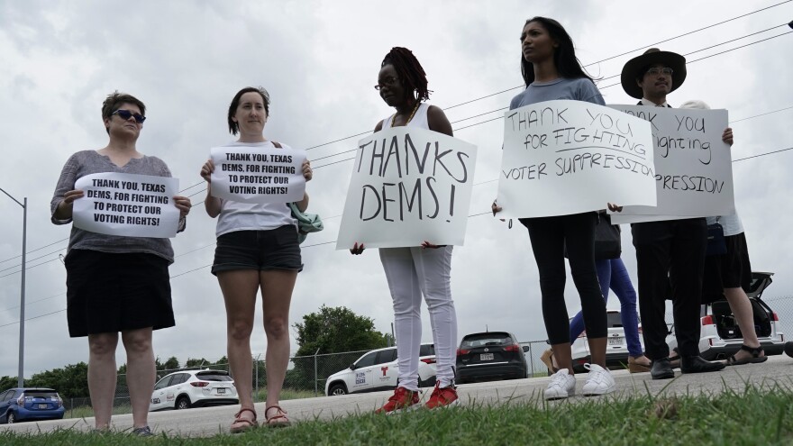 Supporters gather outside Austin's airport Monday as Democrats from the Texas Legislature arrive to board a private plane headed for Washington, D.C. The lawmakers fled to try to block action on GOP election bills.