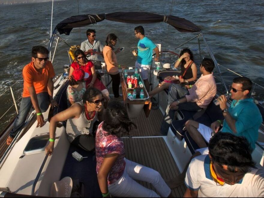 In this photo provided by Floh, single Indians mingle on a sunset cruise organized by the social networking service.