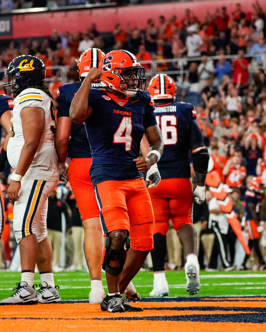 Syracuse running back Ju’Juan Johnson (4, Navy) celebrates in the end zone following his first score of the year.