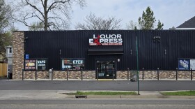 Liquor Express store advertising beer, wine and ATM and lottery tickets.