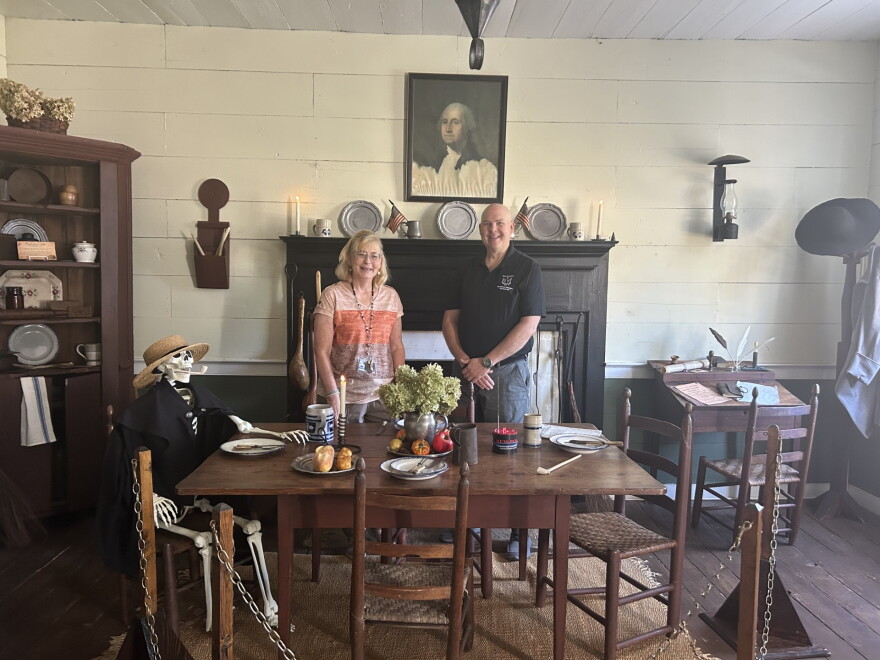 Museum docent Joann Hubert (left) and paranormal investigator Paul Johns (right) with a skeleton friend in the tavern room of the Eagle Tavern Museum in Watkinsville.