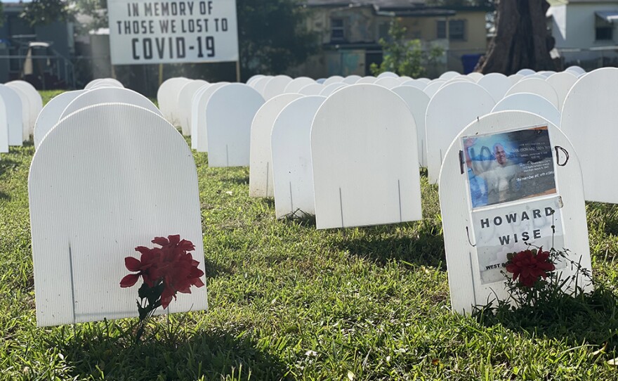 A symbolic cemetery, in memory of neighborhood residents who have died from COVID-19, stands as a memorial in a field at Simonhoff Park in the Liberty City.