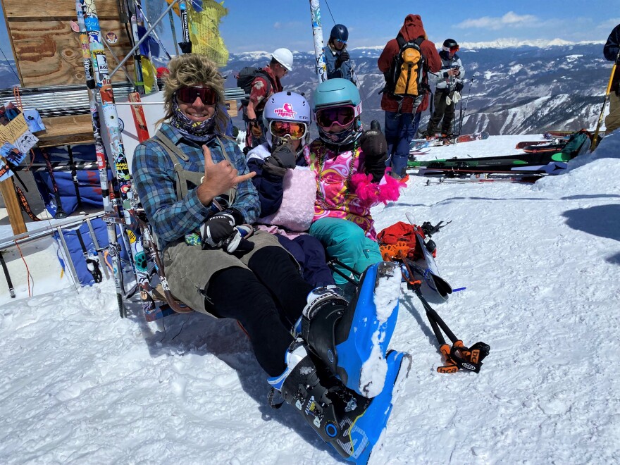 Judd Rogers, Cora and Finn rest before taking off from the top of the Highlands Bowl.