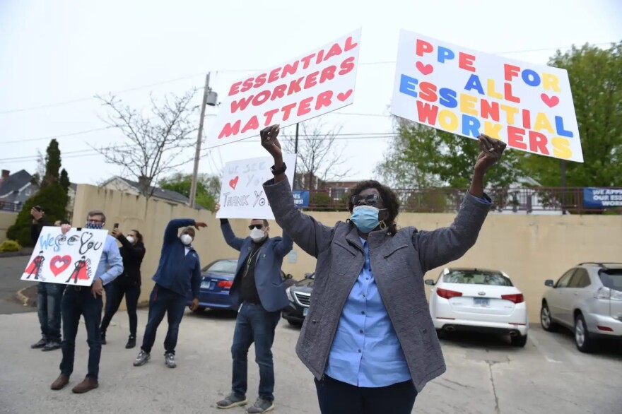 Rep. Pat Billie Miller holds signs supporting health care workers at Golden Hill Rehab Pavilion in Milford in May, 2020.