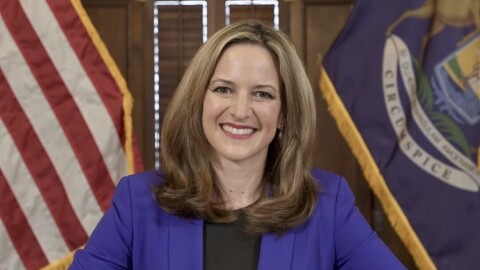 Secretary of State Jocelyn Benson (D), in a brief turn as acting governor, signed a bill Friday to allow voters to request an absentee ballot through a state portal, a policy first adopted during the early days of COVID-19.